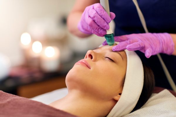 woman having microdermabrasion facial treatment